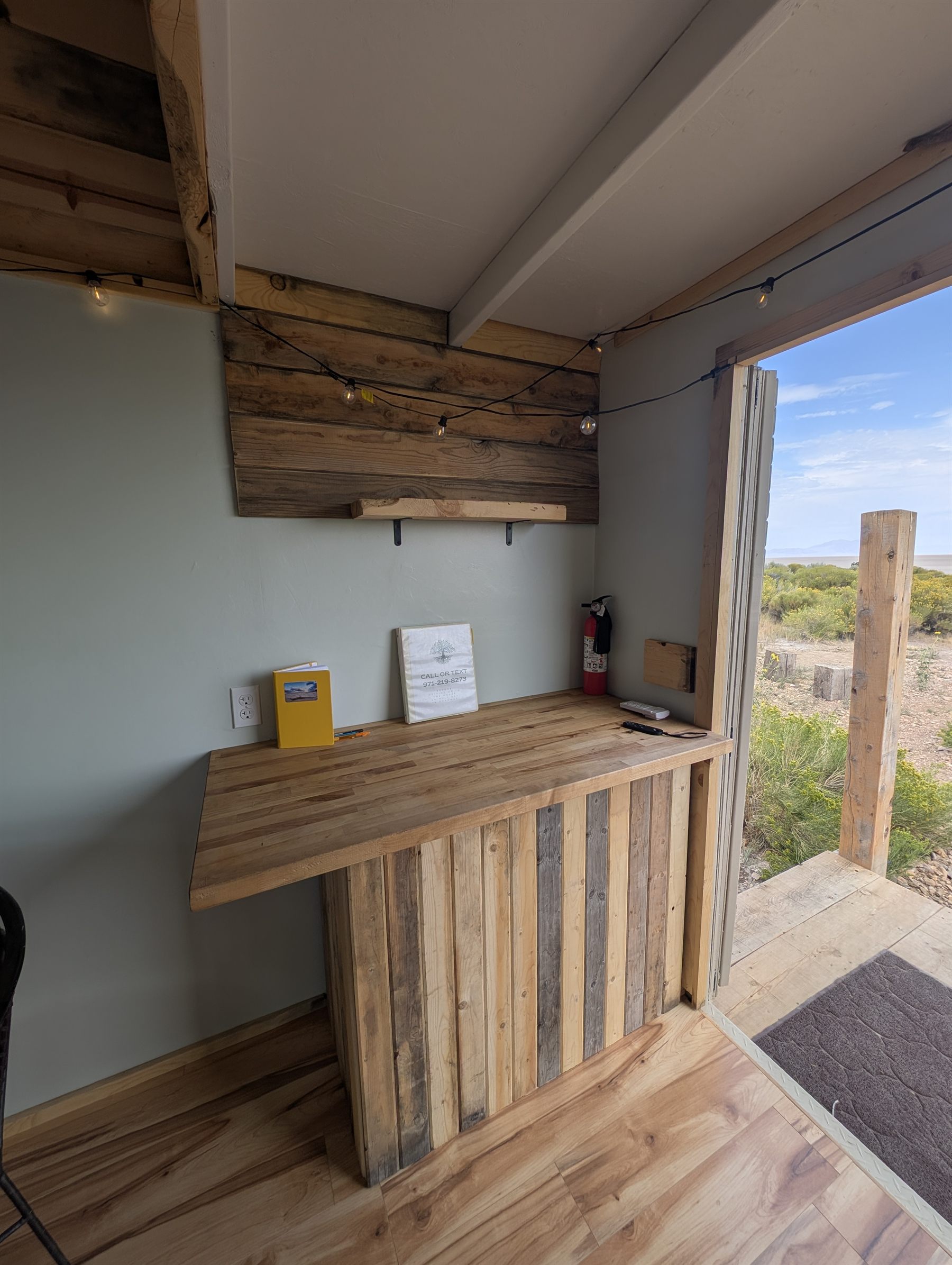 The cabin kitchen counter with the door open to the high desert