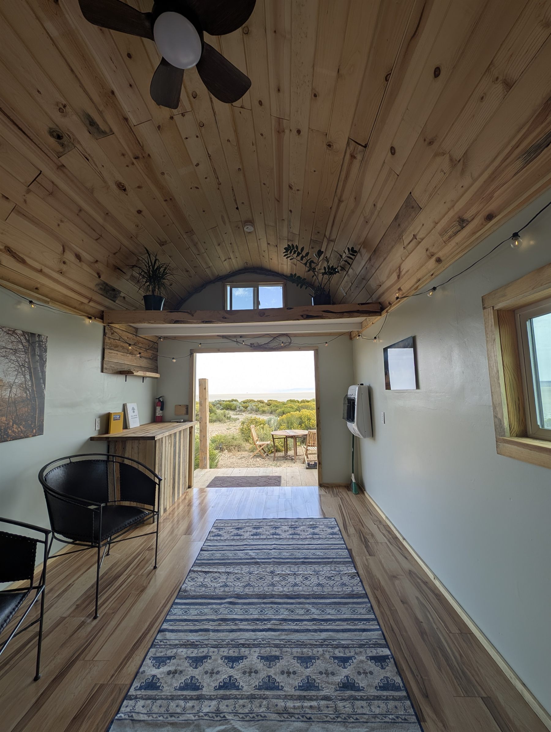 Inside the cabin looking toward the open door and the playa